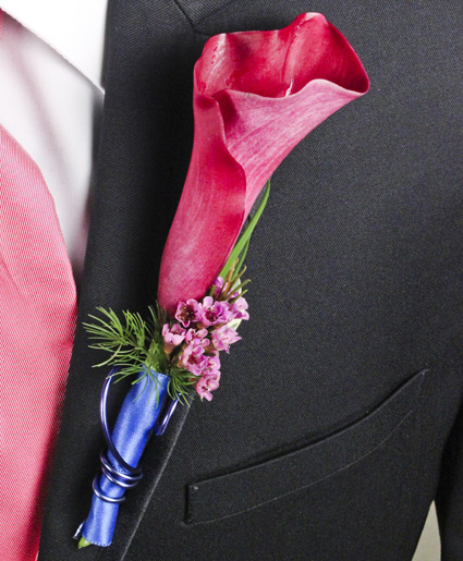 This prom boutonniere features a simple calla lily with hints of green, purple and blue ribbon and wire.