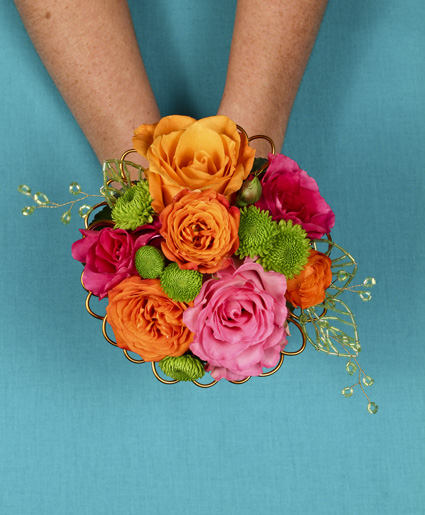 This fun and colorful hand held bouquet features orange, pink & green flowers with fun accents of wire.