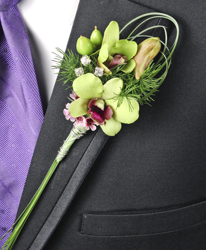This green boutonniere features simple green flowers with unique greenery looping and crystal accents.