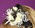 This fun black and white floral head band features white flowers with black and white printed ribbon and feathers. Such a fun added detail to any prom dress.