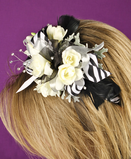 This fun black and white floral head band features white flowers with black and white printed ribbon and feathers. Such a fun added detail to any prom dress.