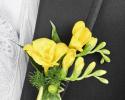 This yellow and green boutonniere features beautiful yellow flowers with hints of green accents. 