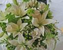 This green and white wedding bouquet, complete with ferns and berries, is perfect for a nature-loving bride. 