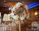Gold is one the latest wedding trends. Give your wedding reception a classy look with fresh roses and gold details with the help of Lindenhurst Village Florist. 